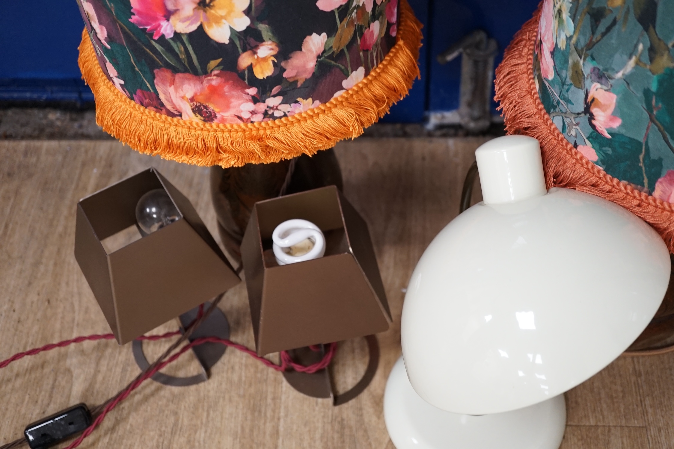 A pair of WMF bronzed metal bedside lamps, a smaller pair and a desk lamp, 36cm high